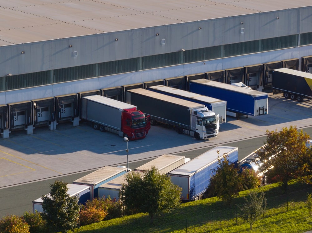 Aerial view of trucks backed onto warehouse loading bays